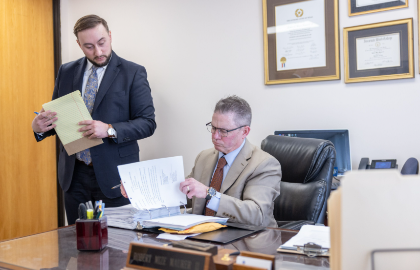 Two lawyers in their office viewing documents