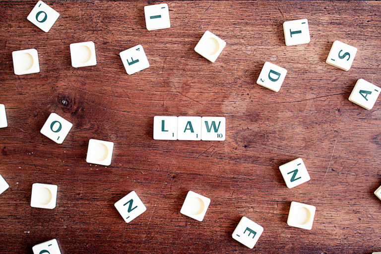 Law written with Scrabble tiles on a wooden background