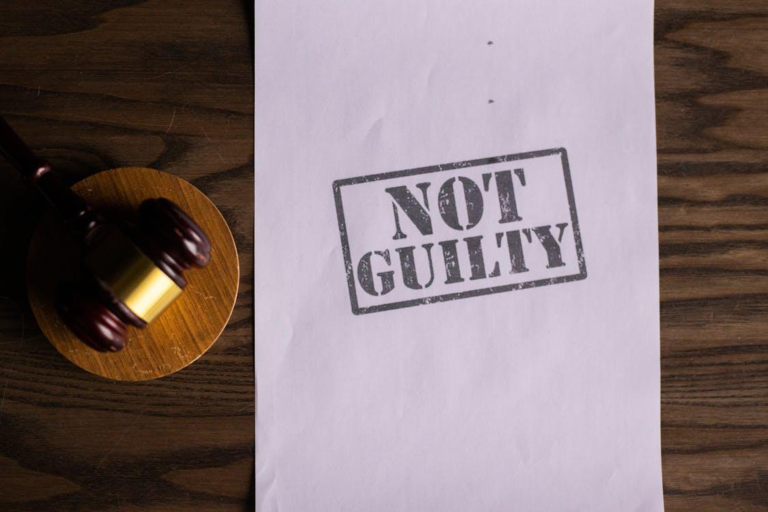 A wooden gavel near a piece of paper