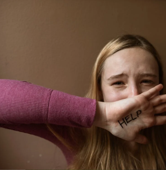 A person asking for abuse by coding it on their hand.