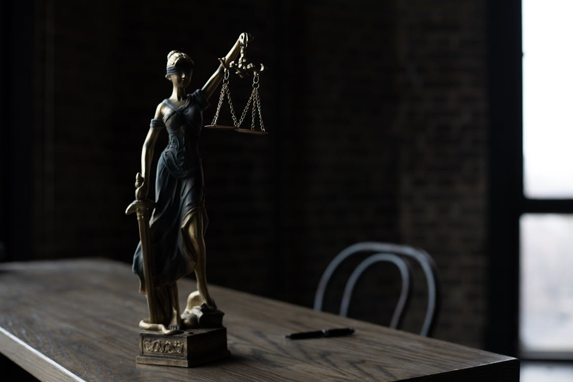  An image of a lady justice statuette on a table      