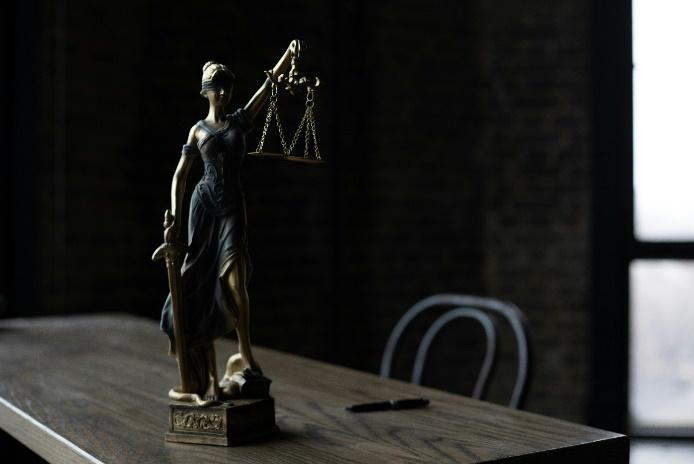 An image of a lady justice statue on a table