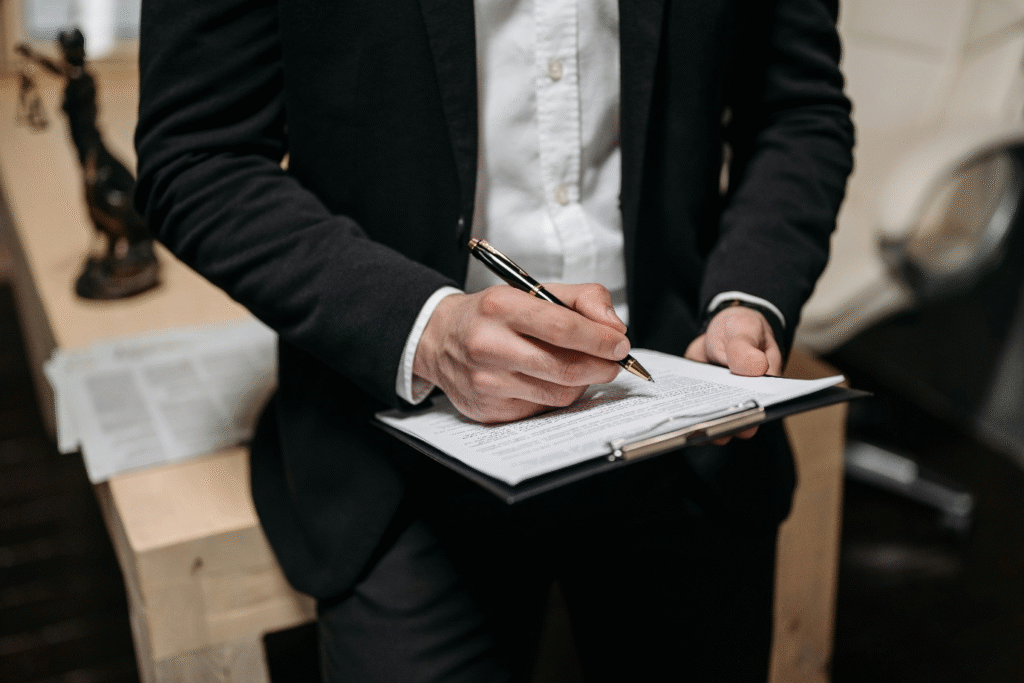 A photo showing a person holding a pen and a clipboard