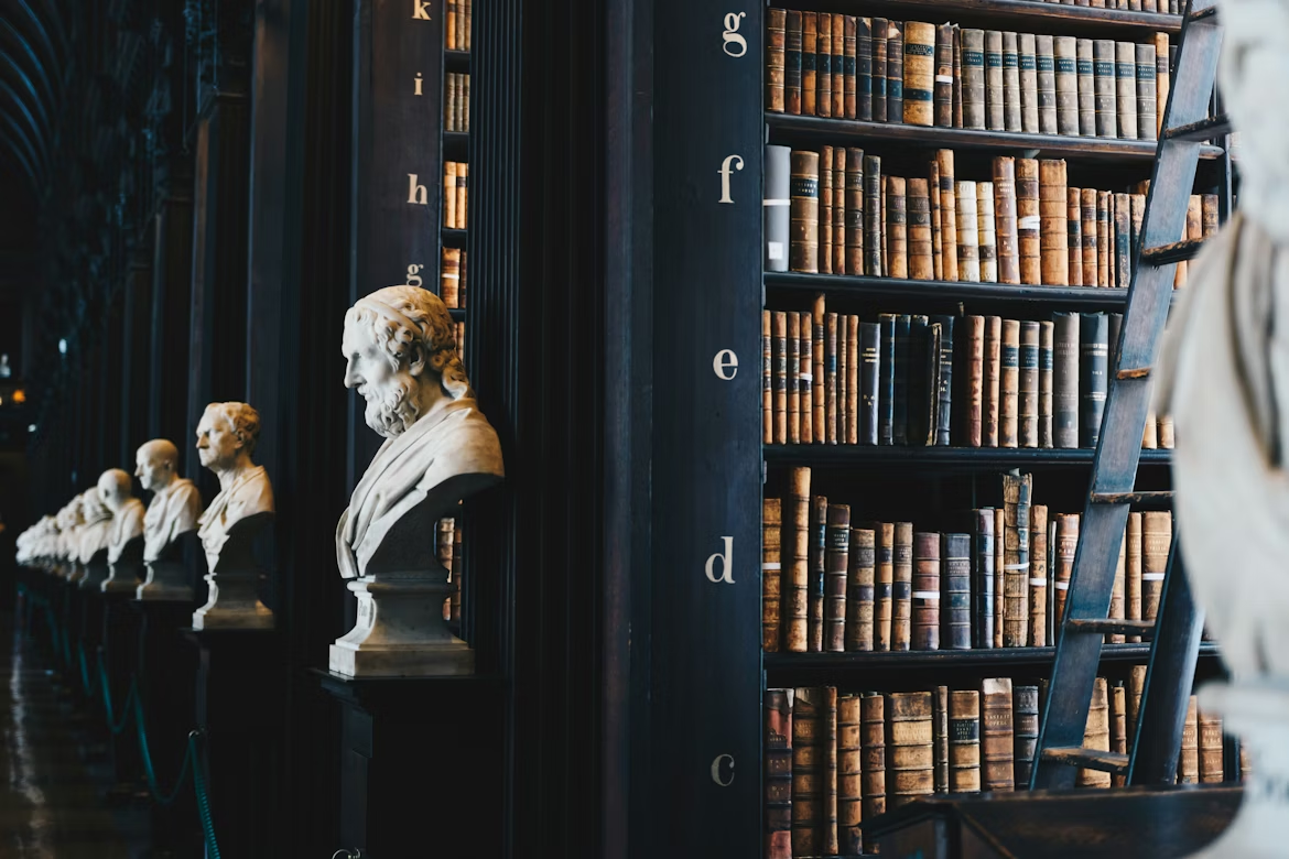 Collection of books arranged on a wooden shelf